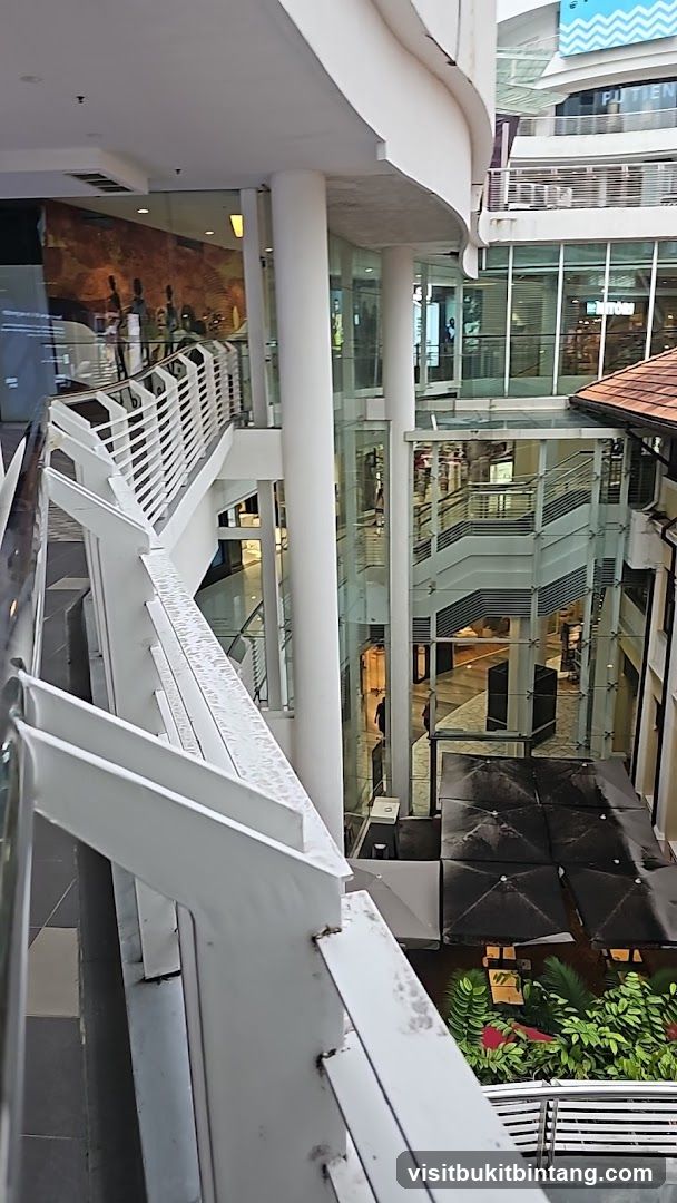 Indoor mall atrium with escalators and shops