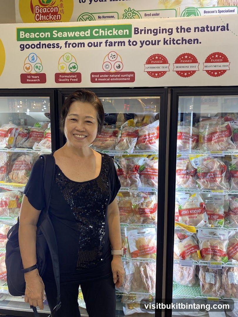 Woman in front of refrigerated display of chicken products