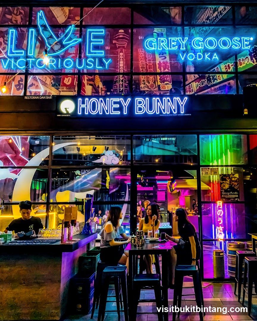 Neon-lit bar interior with patrons