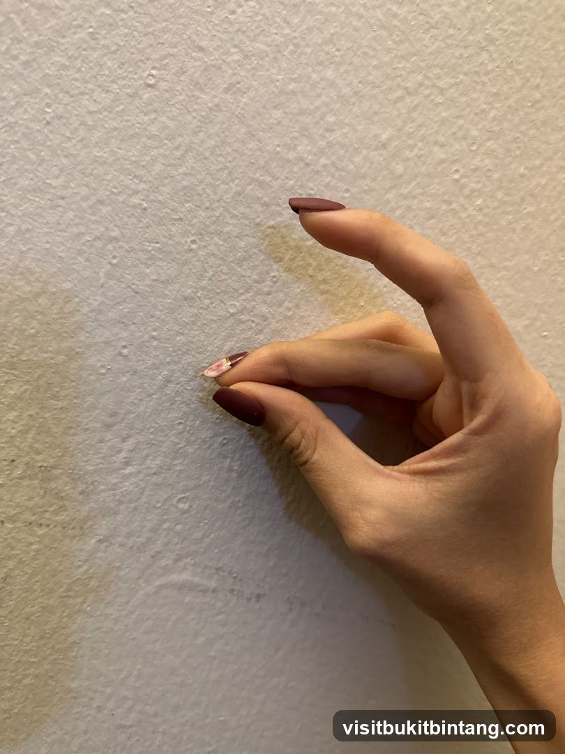 Fingers Pinching Wall