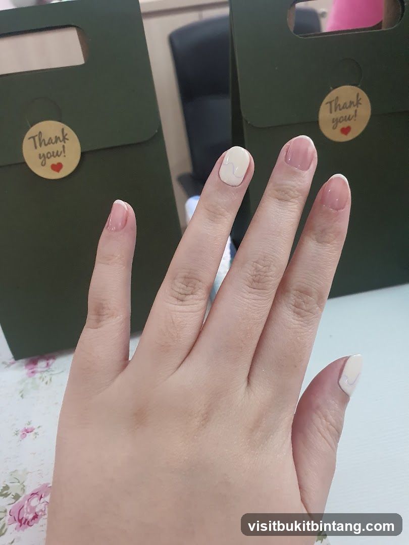 Hand with manicured nails and gift bags