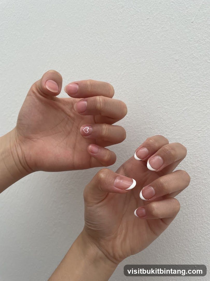 Nails with French tips and a heart design