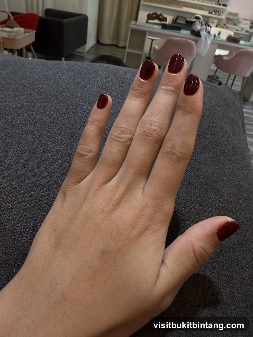 Hand with dark red nails