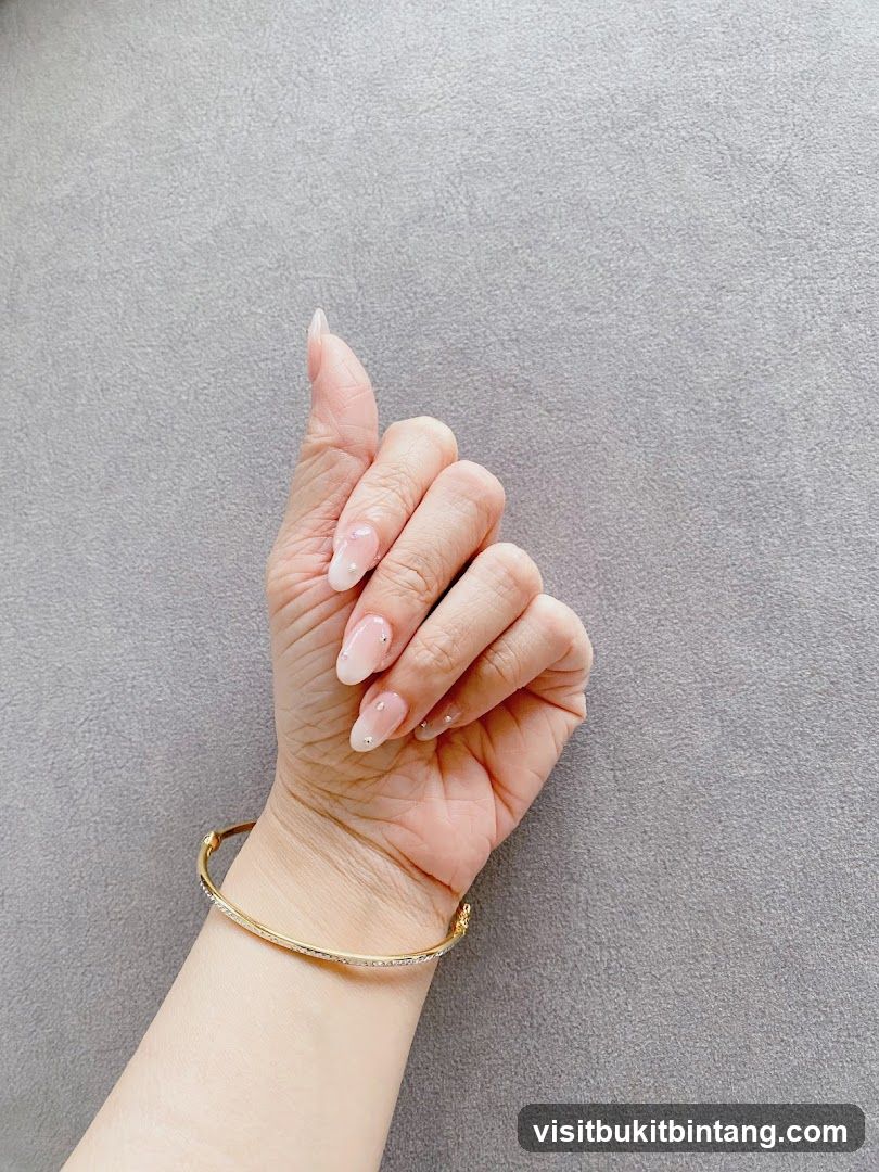 Woman's Hand with French Manicure and Bracelet