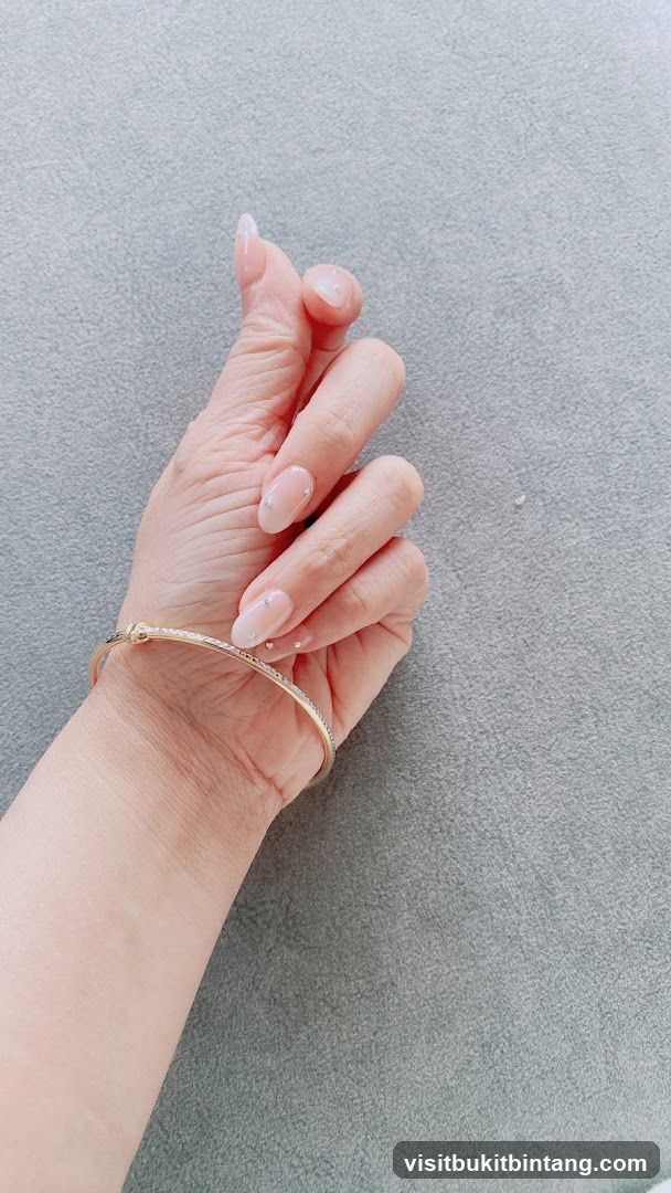 Hand with bracelet and decorated nails