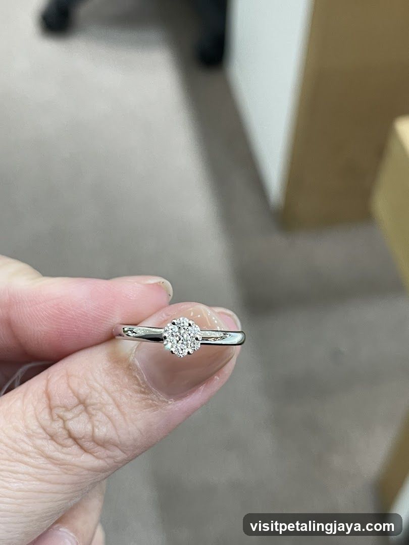 Diamond Ring Held by Finger