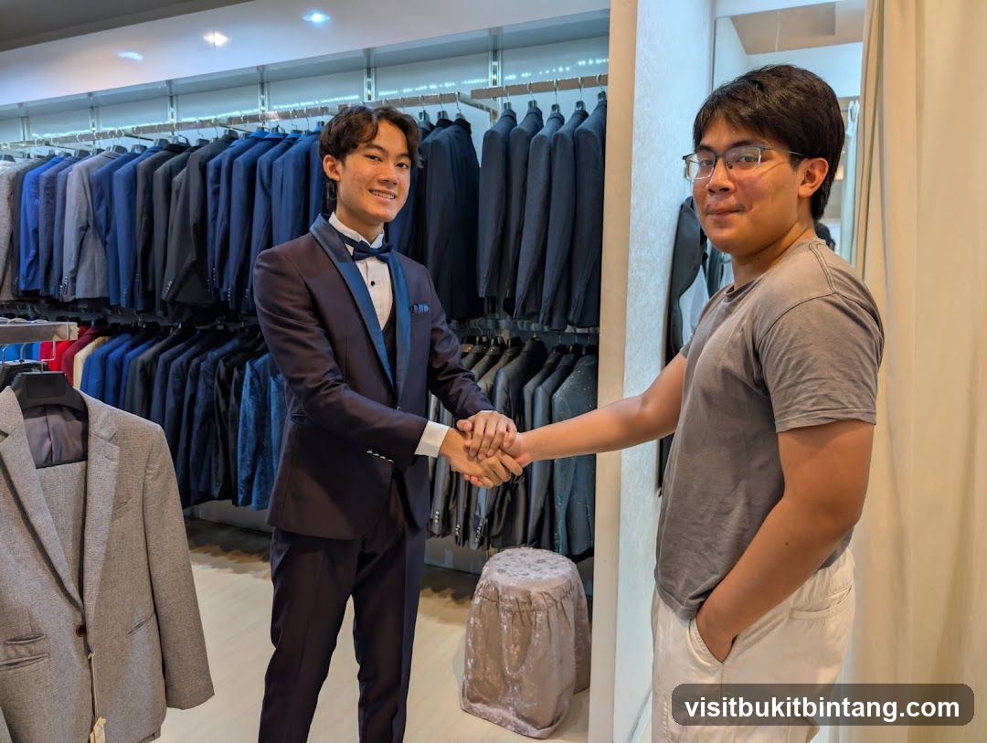 Two young men shaking hands in a suit shop