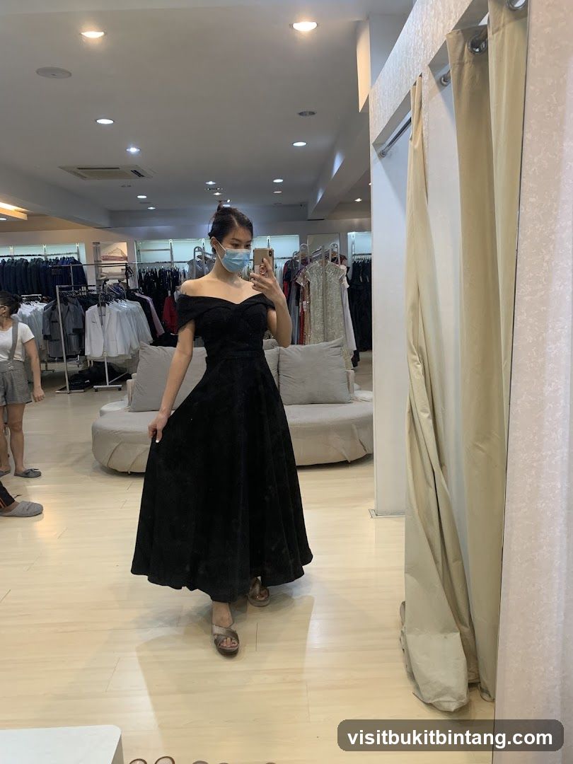 Woman trying on a black dress