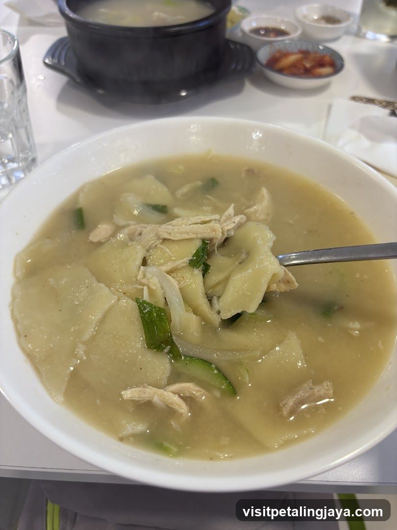 Bowl of Chicken Soup with Potatoes and Greens