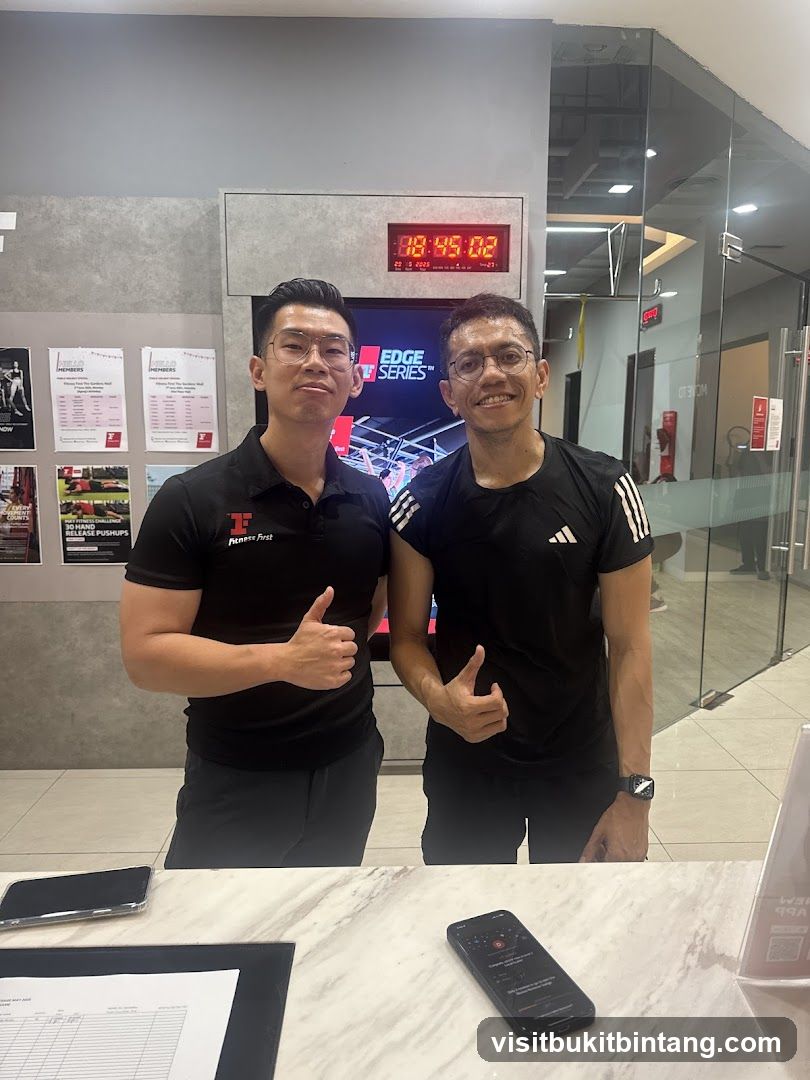 Two men giving thumbs up in a gym