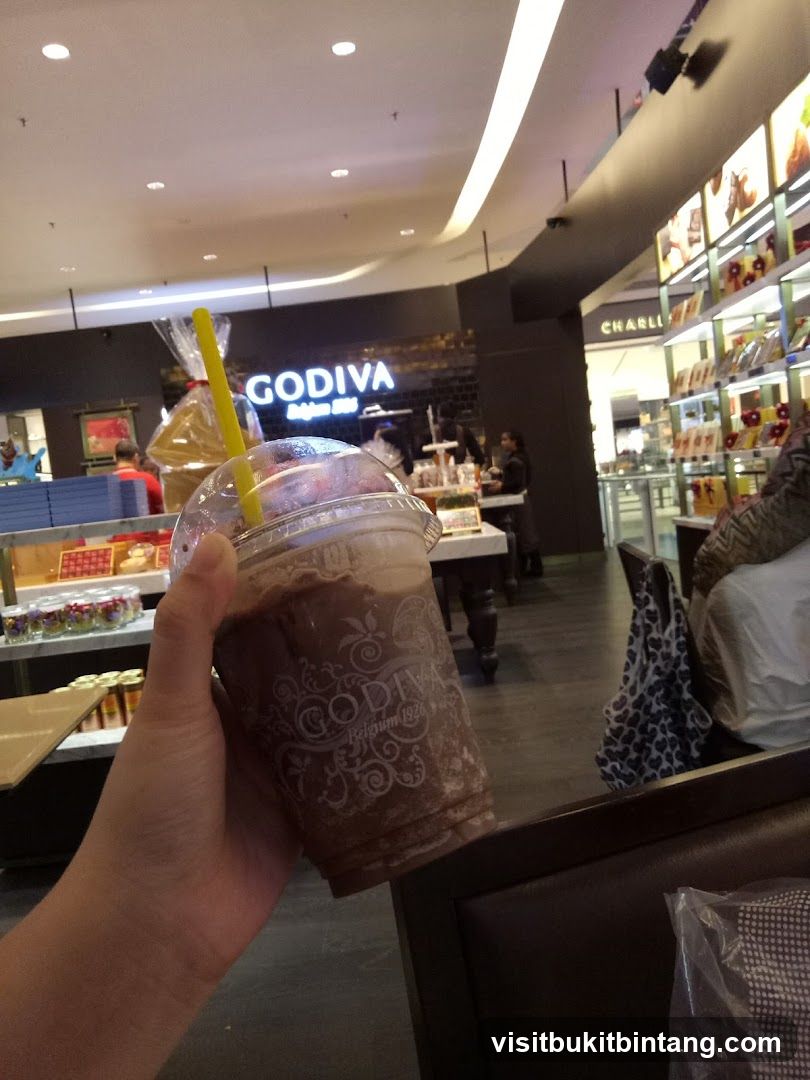 Person holding a Godiva chocolate drink