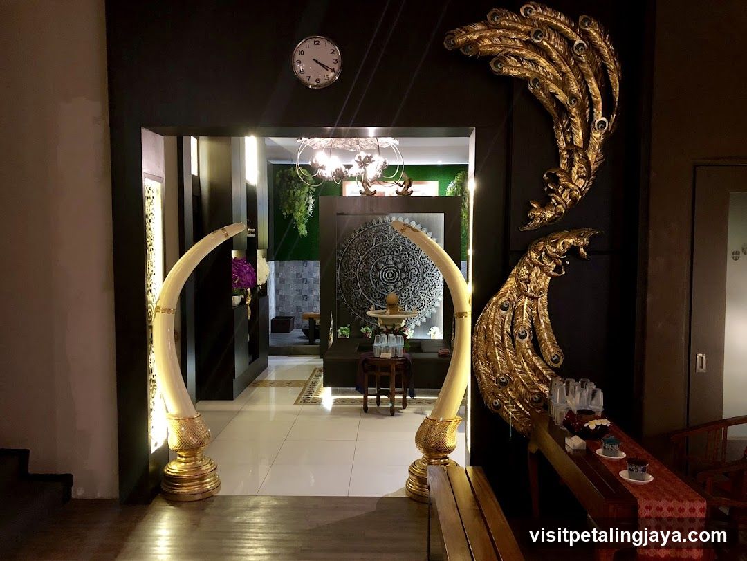 Decorated Interior Entrance with Elephant Tusks and Peacock Art