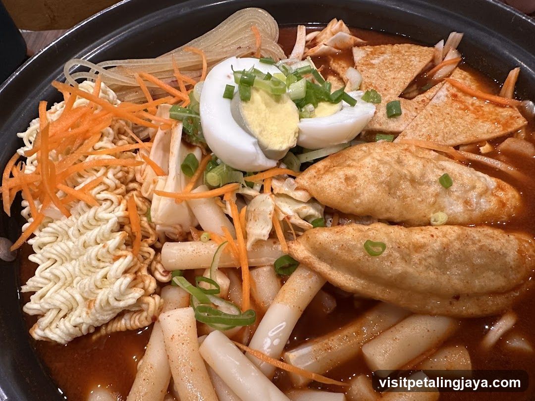 Spicy Rice Cake Bowl with Dumplings and Ramen