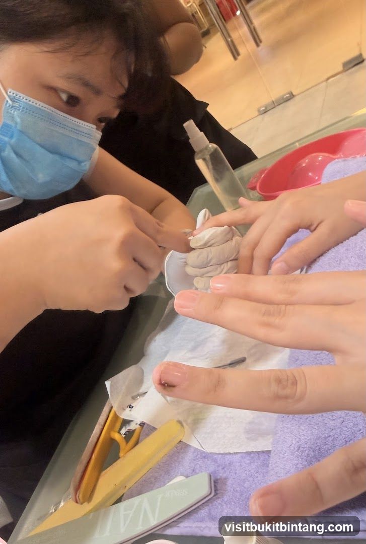Nail Technician Working on Client's Nails