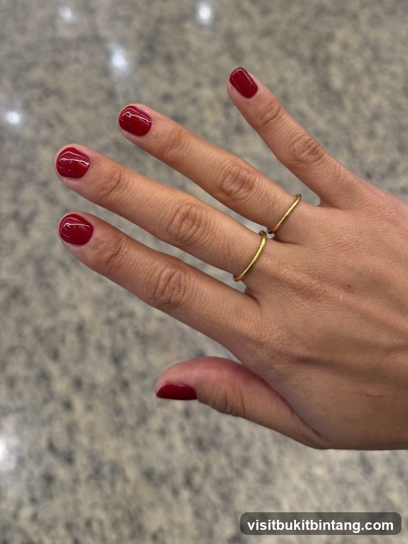 Hands with Red Nail Polish and Rings