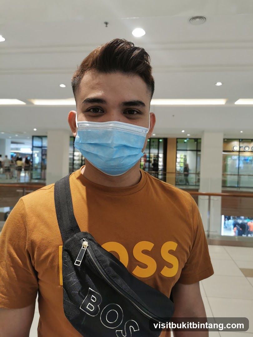 Man wearing a mask and a t-shirt with a logo