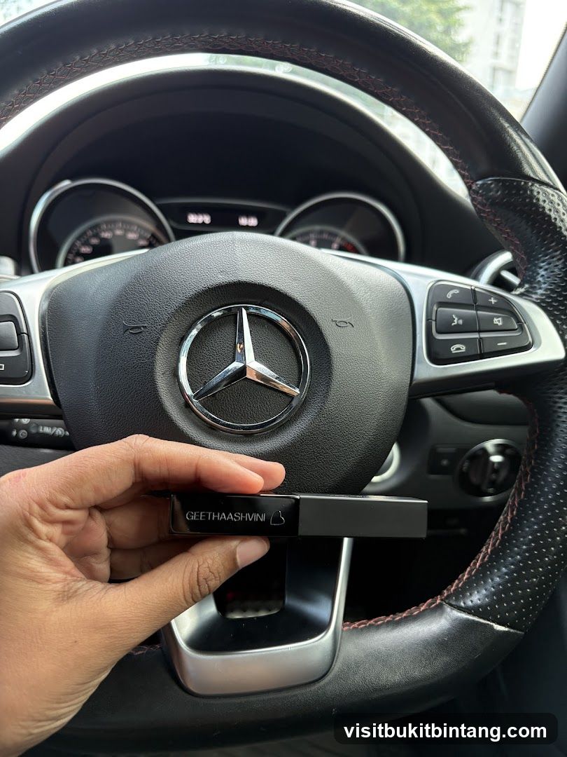 Hand holding a lipstick case in a car