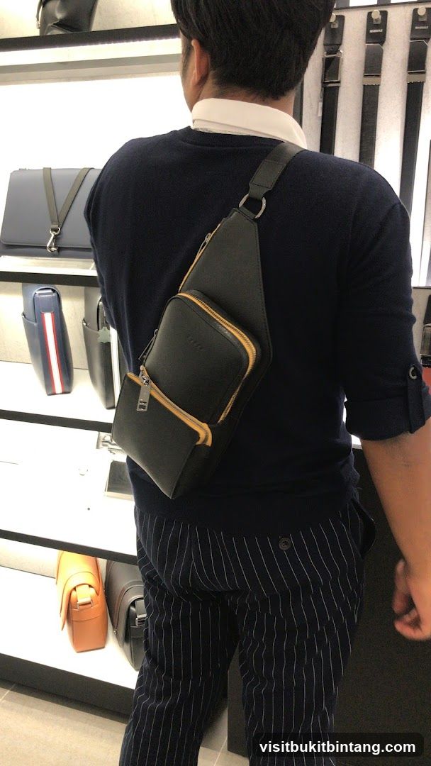 Man wearing a sling bag in a store