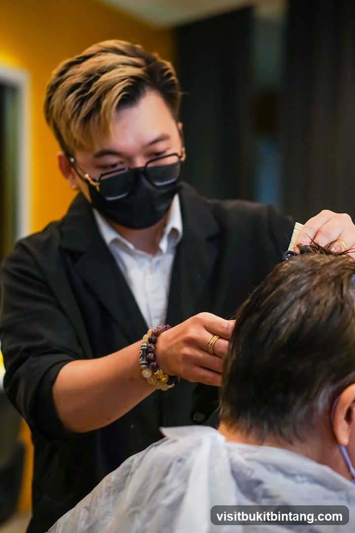 Hairdresser cutting client's hair