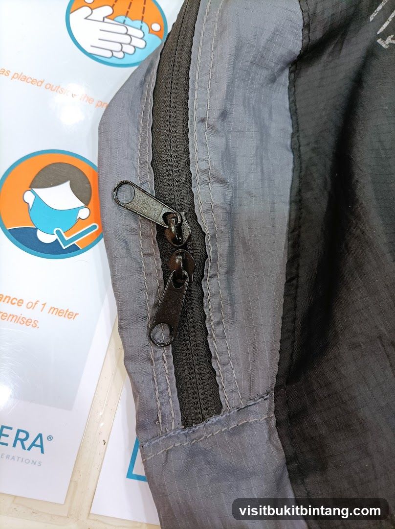 Zipper detail on jacket with safety signage