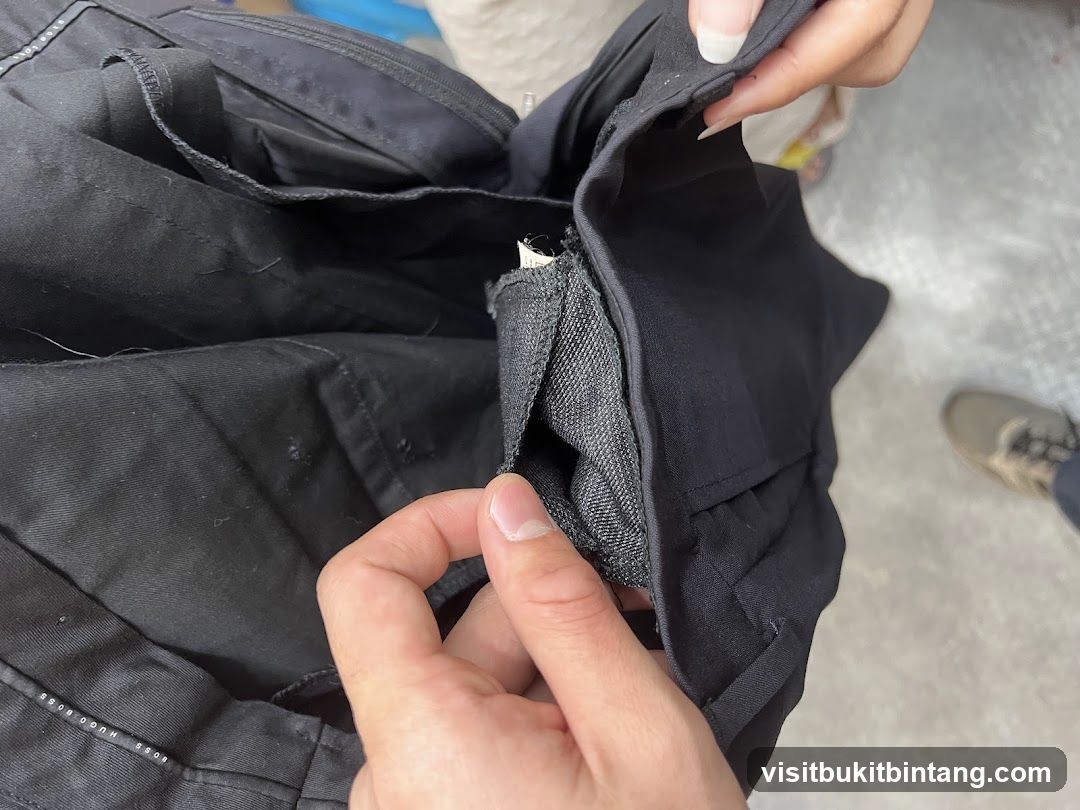 Close-up of black pants with visible label
