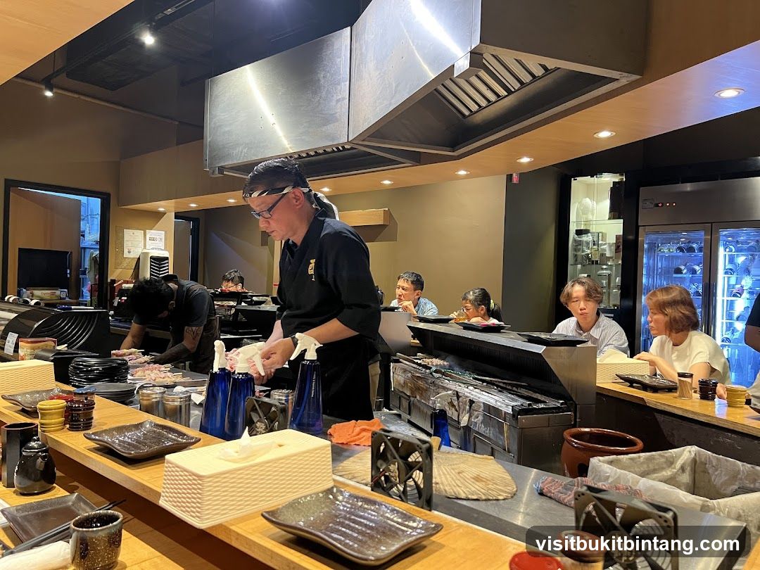 Chefs preparing food at a sushi bar
