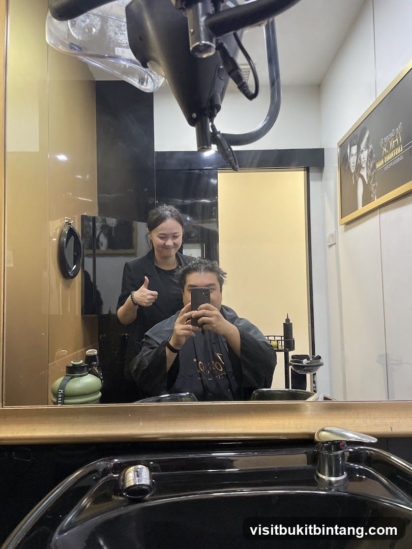 Hairdresser giving a thumbs up to a client