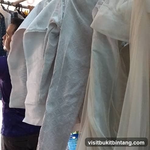 Man looking at clothes on a rack