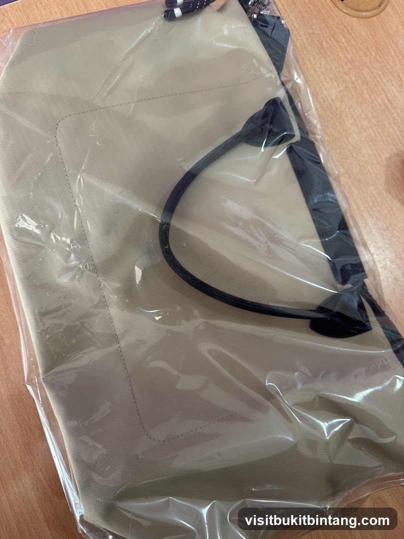 Beige tote bag in plastic packaging