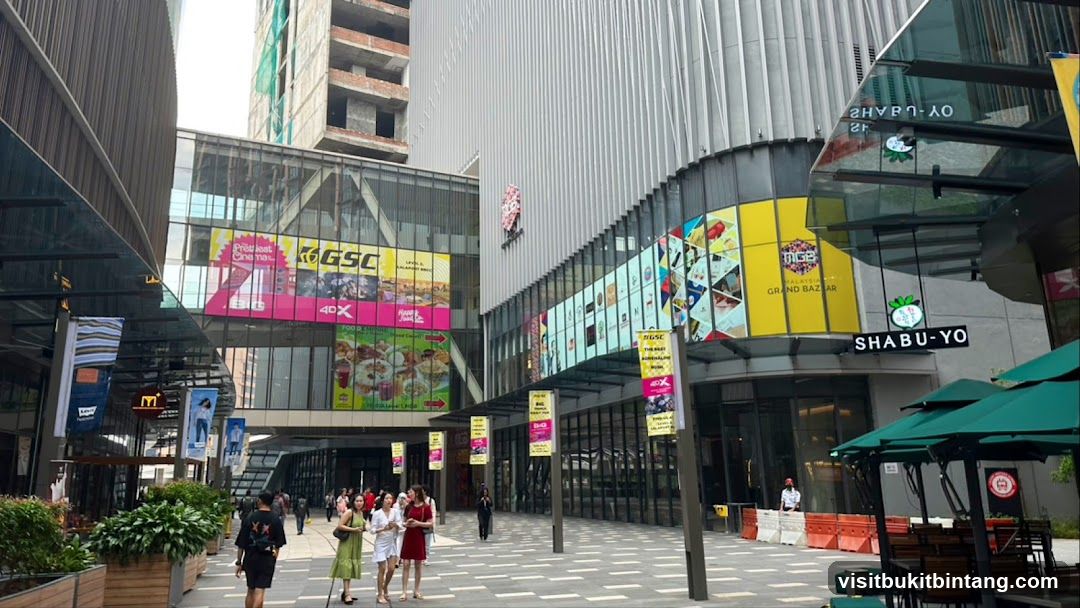 Outdoor shopping mall with various shops and advertisements