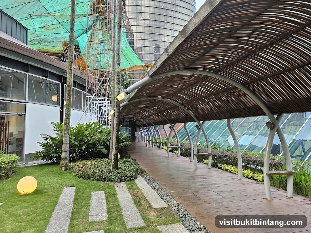 Covered walkway with benches and greenery