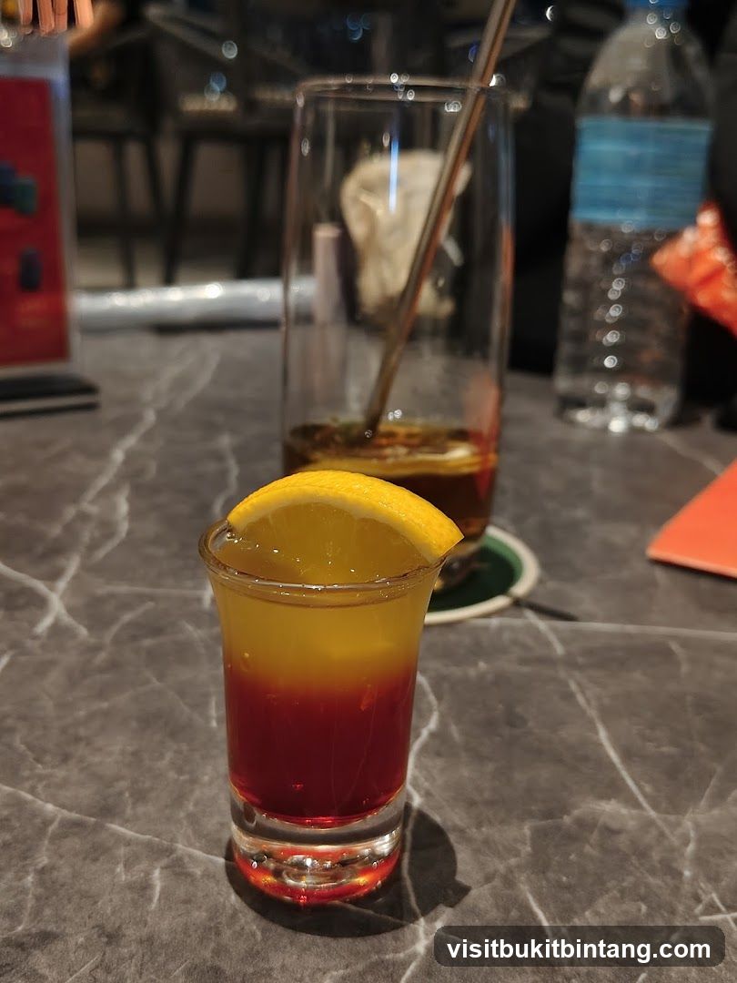 Layered Shot Drink with Orange Garnish