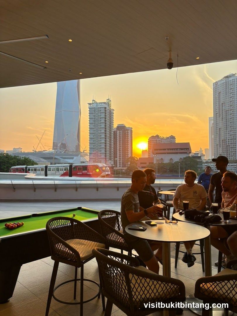 People enjoying drinks at a bar with a city view at sunset
